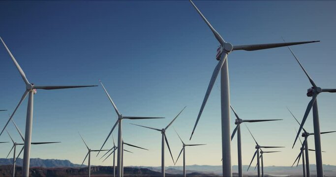 wind turbines against low sun. Green and renewable energy concept. Realistic high quality 4k shot