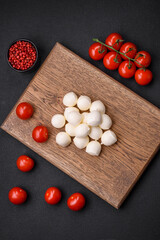 Delicious fresh mozzarella cheese in the form of small balls with salt and spices