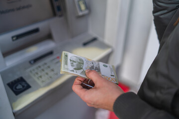 A close up of man hand holding money dinars  - obrazy, fototapety, plakaty