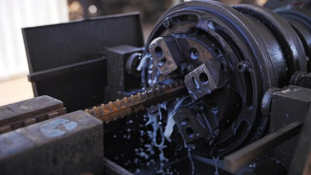 Construction machine for threading fittings on rebar