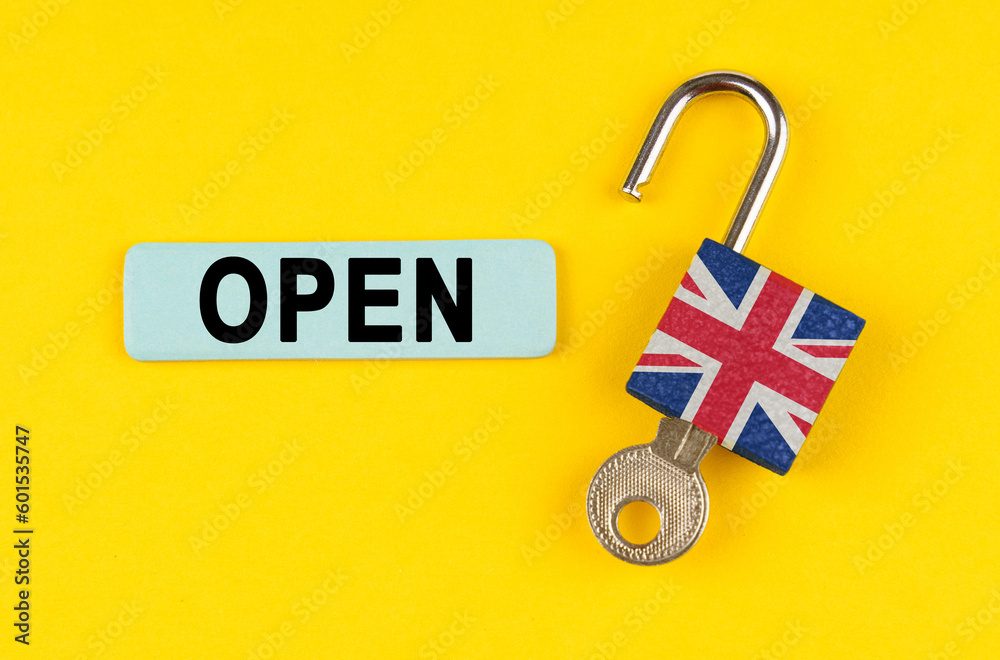 Poster On the yellow surface is an open lock with a key and a sticker with the inscription - open