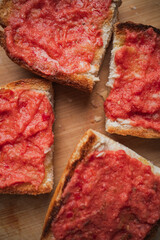 Close up of four toasts with olive oil and crushed tomato. Spanish breakfast.