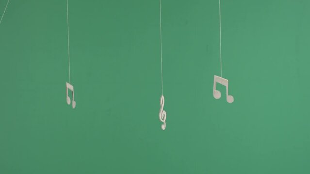 three musical notes on green background, chroma key