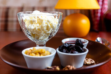 Homemade Breakfast. Cottage Cheese with Cinnamon, Jam, Nuts and Blueberries.