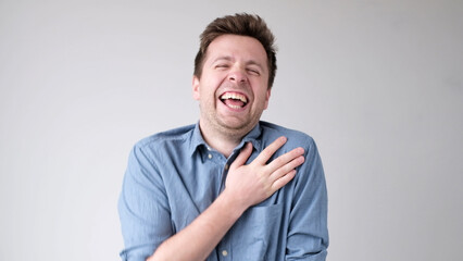 European funny young man is laughing loudly. Positive emotion