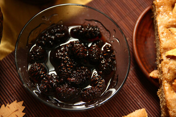 Jam from cones in a transparent bowl on the table.