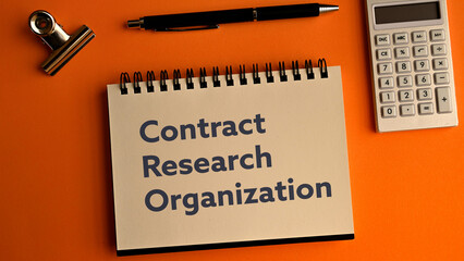 There is notebook with the word Contract Research Organization.It is as an eye-catching image.