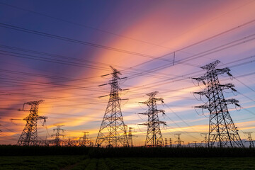 Fototapeta premium In the evening, the silhouette of high voltage towers