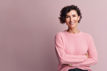 Obraz premium Portrait of a beautiful middle-aged woman on a pink background