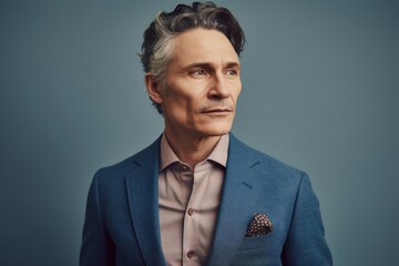 Portrait of a handsome middle-aged man in a blue suit.