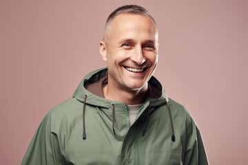 Portrait of a smiling mature man in a green raincoat.