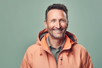 Fototapeta premium Portrait of a smiling middle-aged man in an orange jacket.