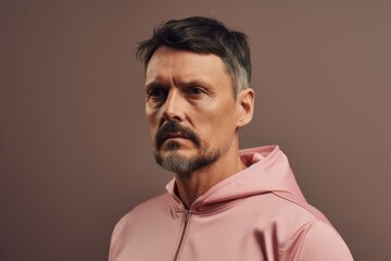 Fototapeta premium Portrait of a middle-aged man in a pink hoodie.