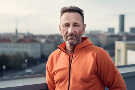 Portrait of handsome middle-aged man in orange sportswear.