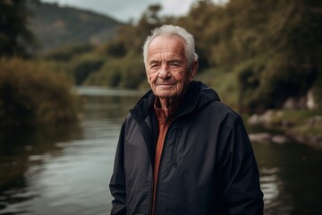 Portrait of an elderly man on the background of a river.