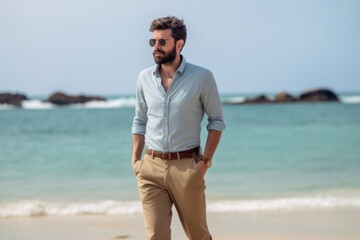 Medium shot portrait photography of a tender man in his 30s wearing a smart pair of trousers against an island or beach paradise background. Generative AI