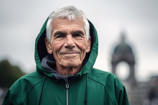 Environmental portrait photography of a pleased man in his 60s wearing a stylish hoodie against a historic monument or landmark background. Generative AI