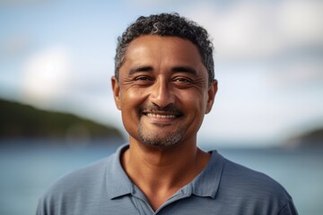 Close up portrait of a smiling middle-aged man on the beach