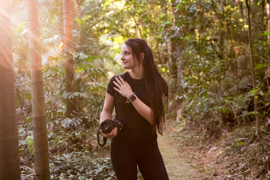Brazilian woman photographs in nature in golden light