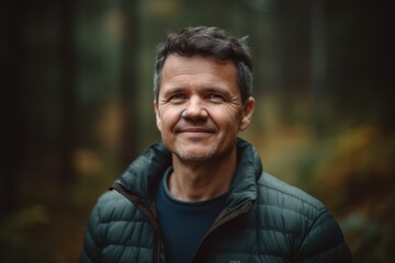 Portrait of a smiling man in the autumn forest. Portrait of a man in the forest.
