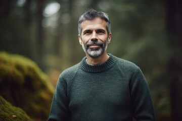 Naklejka premium Portrait of a handsome middle-aged man in the autumn forest