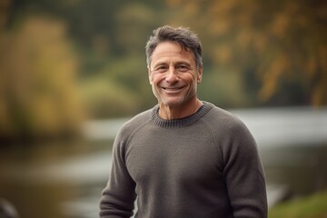 Portrait of smiling middle-aged man in a park in autumn