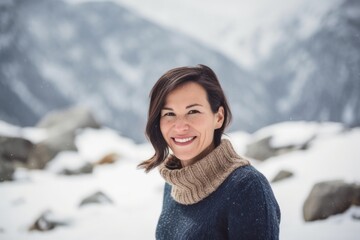 Portrait of a beautiful woman on a background of mountains in winter