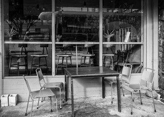 Closed Takeout Snack Shop with a Metal table and Chairs Outside, 