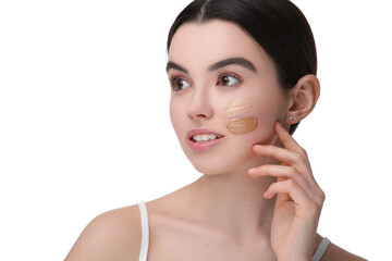 Teenage girl with swatches of foundation on face against white background