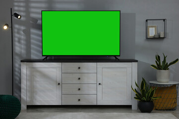 Chroma key compositing. TV with mockup green screen in room. Mockup for design