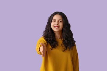 Teenage girl in yellow sweatshirt reaching out for handshake on lilac background