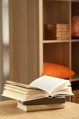 Stack of different books on wooden table indoors, space for text