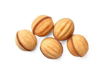 Delicious nut shaped cookies with condensed milk on white background, top view