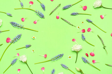 Frame made of Muscari and eustoma flowers on green background