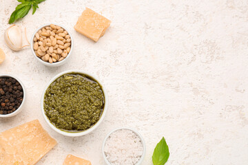 Fototapeta na wymiar Composition with bowl of pesto sauce and ingredients on white table