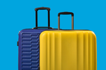 Big suitcases on blue background, closeup