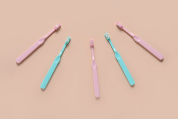 Frame made of toothbrushes on orange background