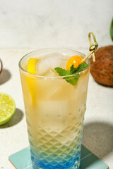 Fresh summer cocktail with lemon, winter cherry and mint on white grunge background