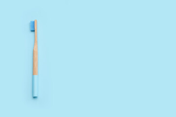 Bamboo toothbrush on blue background