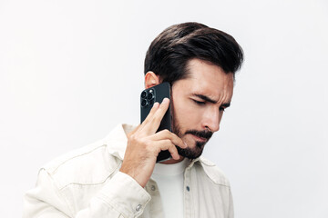 Closeup portrait man talking on the phone angry annoyance and quarrel on white isolated background, fashion style clothes, copy space, space for text