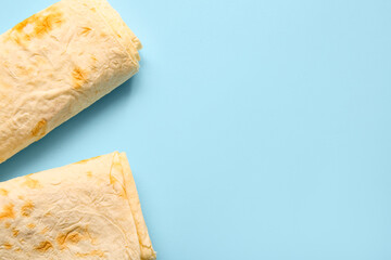 Fresh thin lavash on blue background