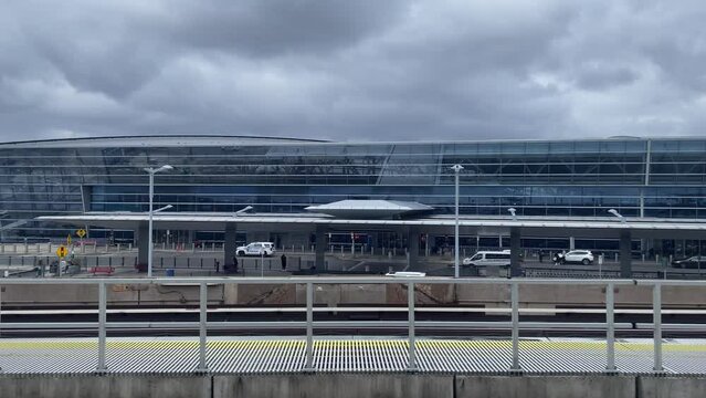 SLOW MOTION SHOT OF jfk airport entering the passenger terminal building on a cloudy day