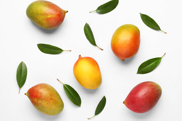 Fresh ripe mangoes on light background