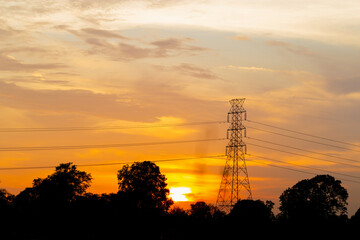 Silhouette of High voltage electric tower at sunset evening time, Sky at sunset time background