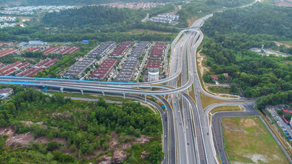 Aerial view of residential area with green asphalt road and residential houses directly above viewpoint. View of suburbs and city district. Real estate and housing market concept. - 601572533