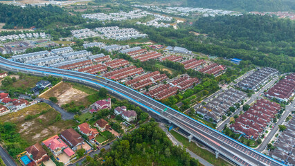 Aerial view of residential area with green asphalt road and residential houses directly above viewpoint. View of suburbs and city district. Real estate and housing market concept. - 601572547