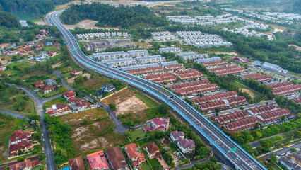 Aerial view of residential area with green asphalt road and residential houses directly above viewpoint. View of suburbs and city district. Real estate and housing market concept. - 601572551