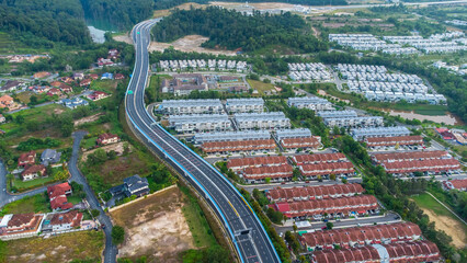 Aerial view of residential area with green asphalt road and residential houses directly above viewpoint. View of suburbs and city district. Real estate and housing market concept. - 601572561