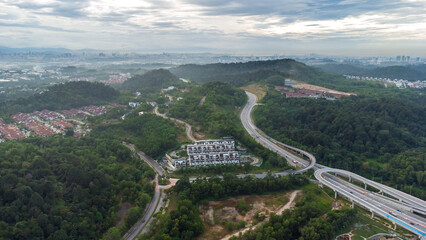 Aerial view of residential area with green asphalt road and residential houses directly above viewpoint. View of suburbs and city district. Real estate and housing market concept. - 601572572