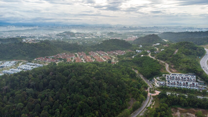 Aerial view of residential area with green asphalt road and residential houses directly above viewpoint. View of suburbs and city district. Real estate and housing market concept. - 601572576